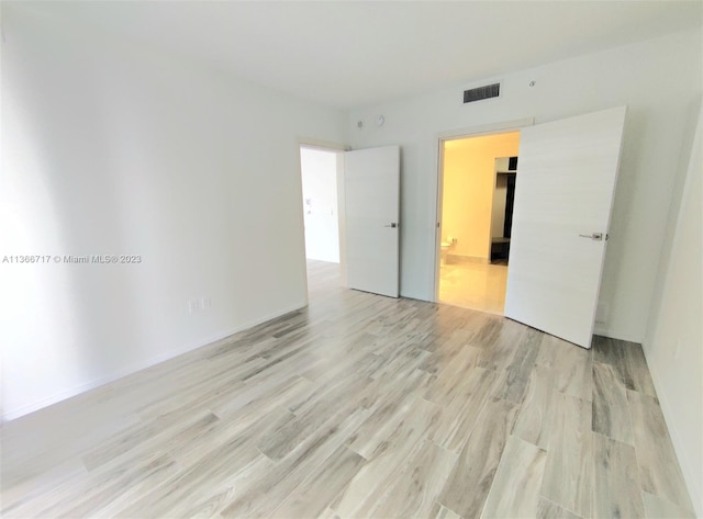 unfurnished room with light hardwood / wood-style flooring