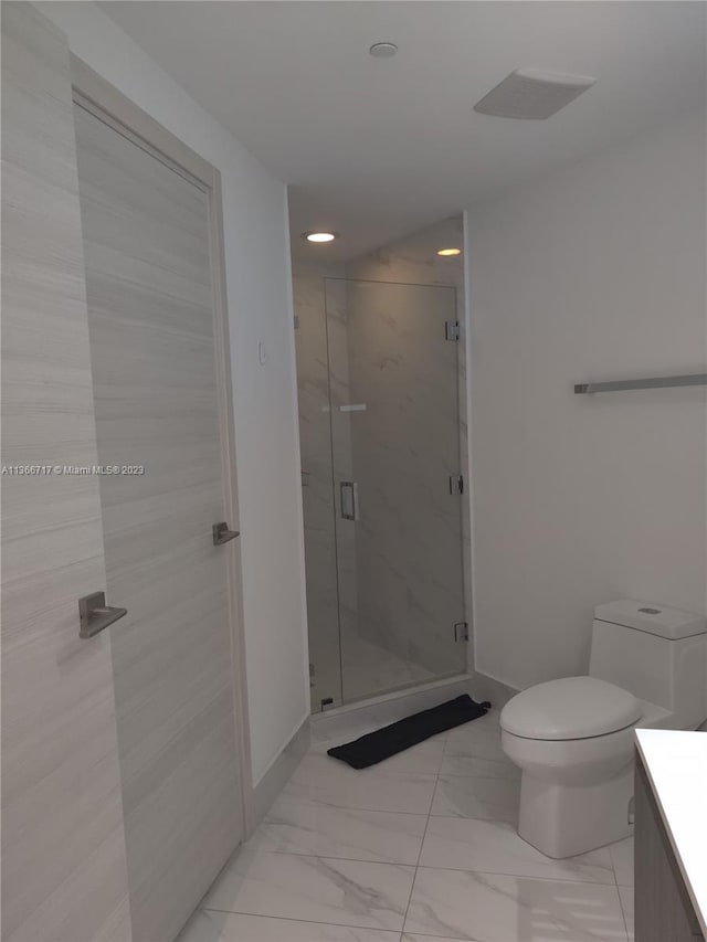 bathroom featuring walk in shower, vanity, and toilet