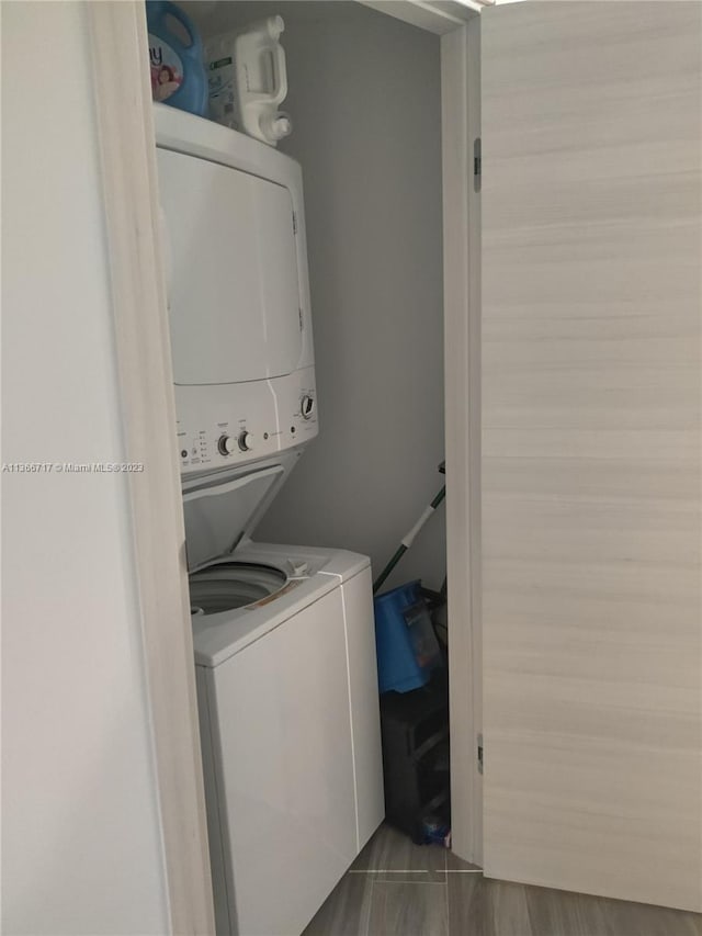 laundry area with stacked washer and dryer