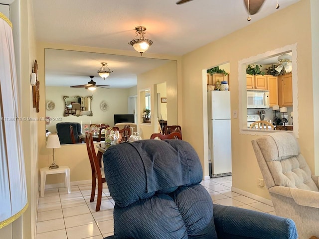 tiled living room with ceiling fan