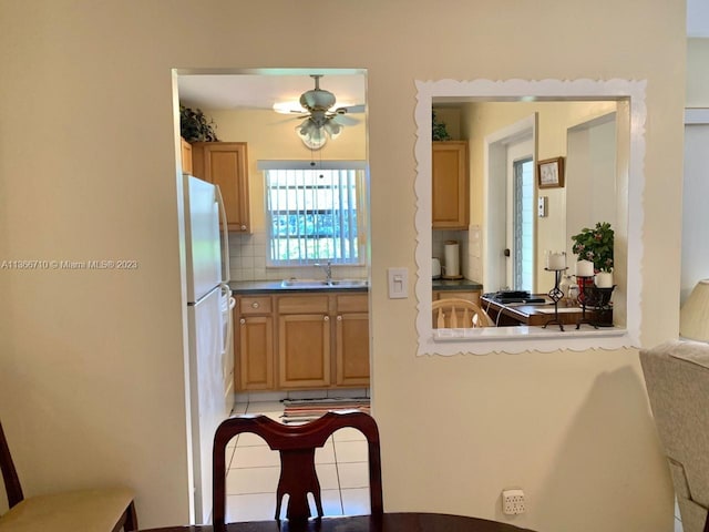 kitchen with light tile floors, tasteful backsplash, ceiling fan, and sink