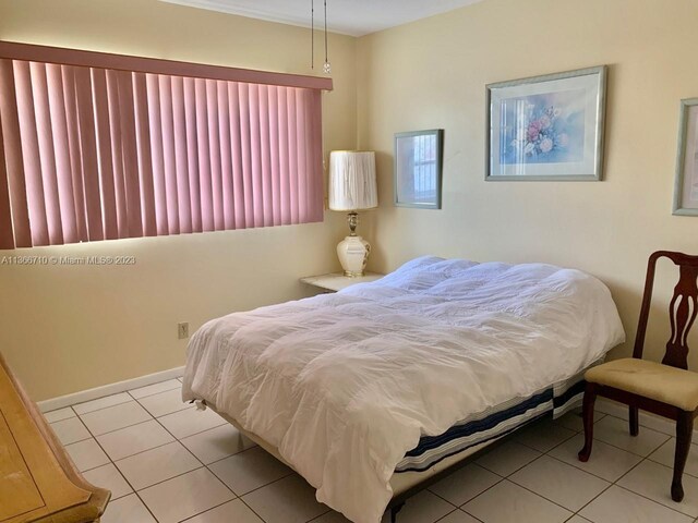 bedroom with light tile floors