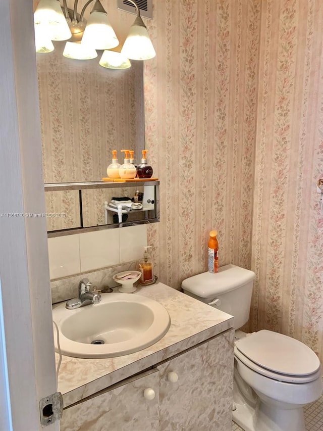 bathroom with vanity, tile flooring, and toilet