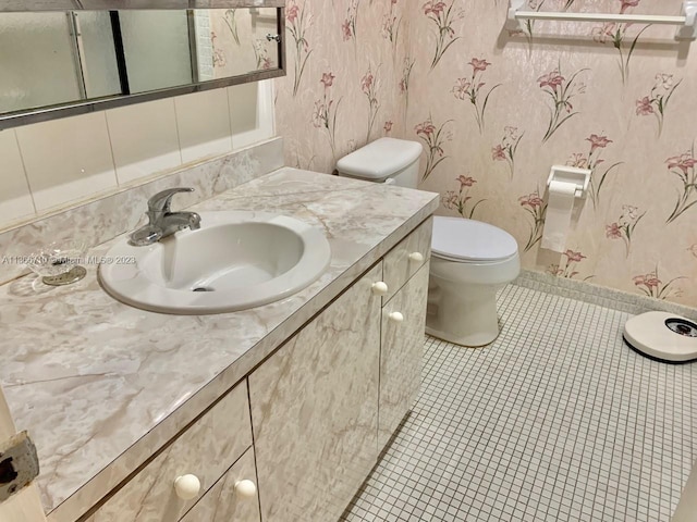 bathroom featuring tile flooring, oversized vanity, and toilet