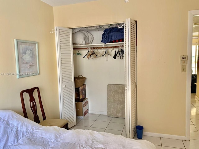 bedroom featuring light tile flooring and a closet