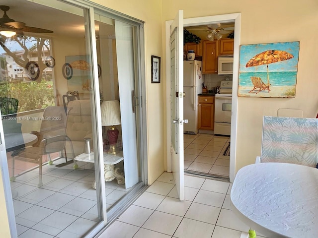 interior space featuring white refrigerator, a closet, and light tile floors