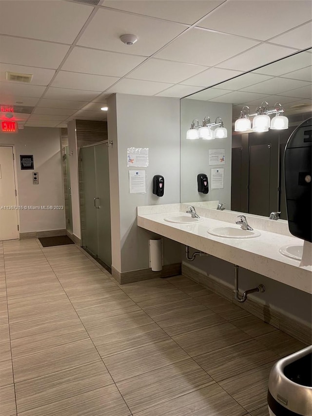 bathroom featuring walk in shower, a paneled ceiling, tile patterned floors, and vanity