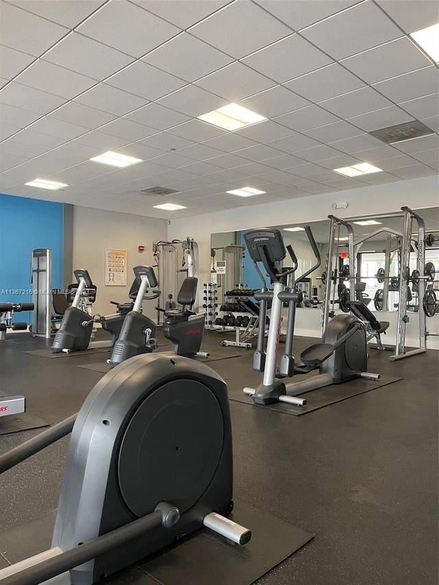 exercise room with a paneled ceiling