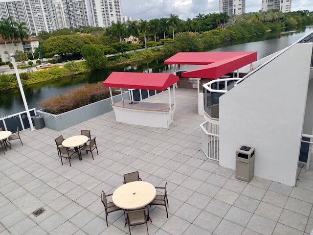 view of patio / terrace featuring exterior bar and a water view