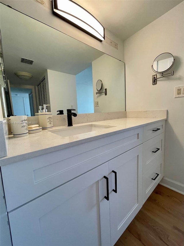 bathroom featuring vanity and wood-type flooring