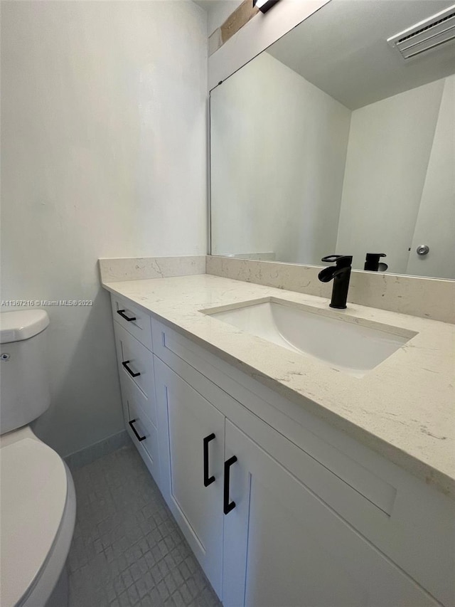 bathroom featuring vanity and toilet