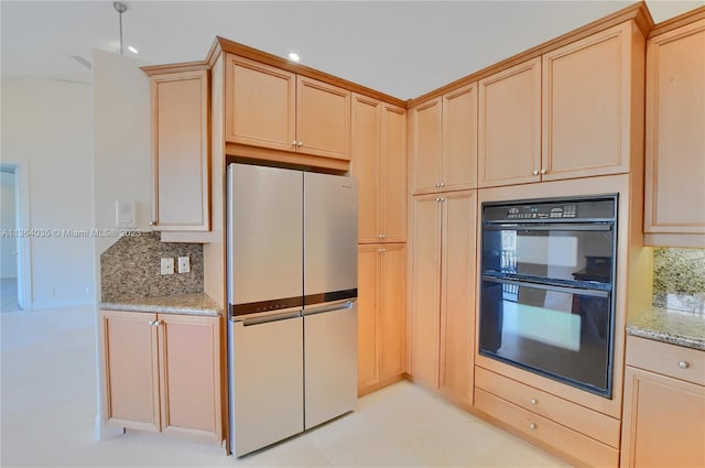 kitchen with backsplash, white fridge, double oven, light tile floors, and light stone counters