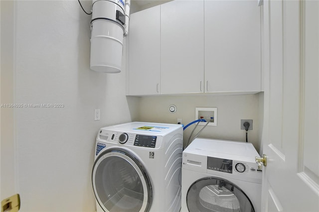 washroom with washer and dryer, electric dryer hookup, hookup for a washing machine, and cabinets