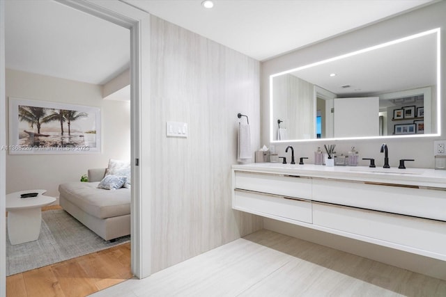 bathroom featuring a bidet, double vanity, and wood-type flooring