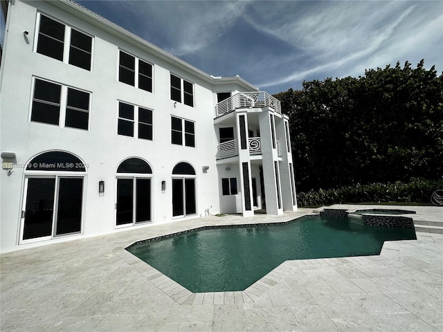 view of swimming pool with a patio and an in ground hot tub