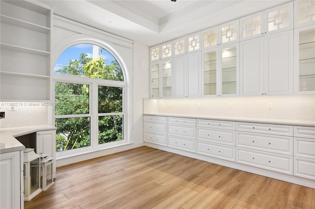 interior space featuring plenty of natural light, hardwood / wood-style floors, and ornamental molding