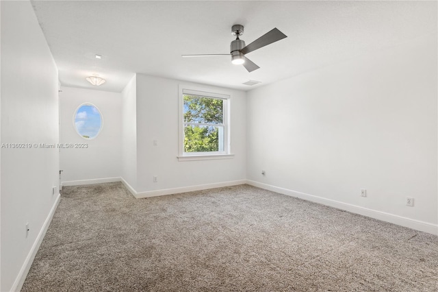 unfurnished room featuring light carpet and ceiling fan