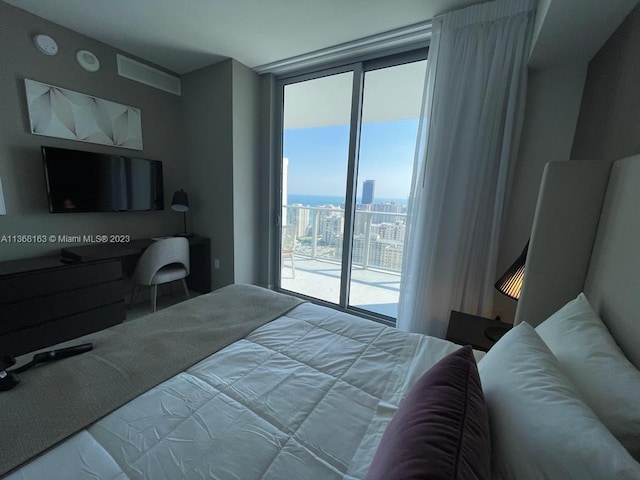 bedroom featuring access to exterior and expansive windows