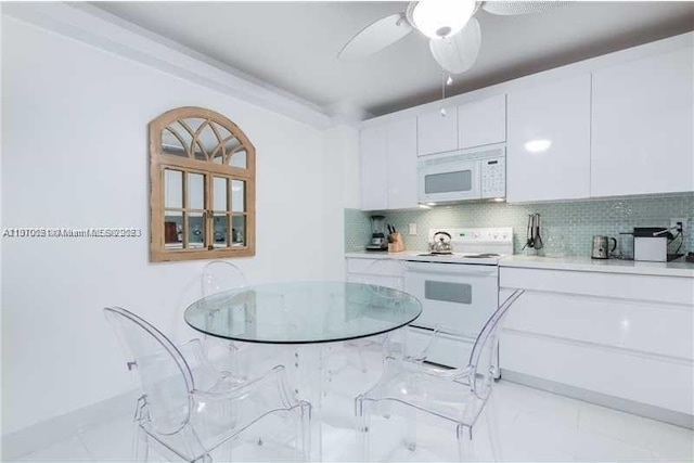 kitchen with light tile floors, ceiling fan, tasteful backsplash, white appliances, and white cabinets