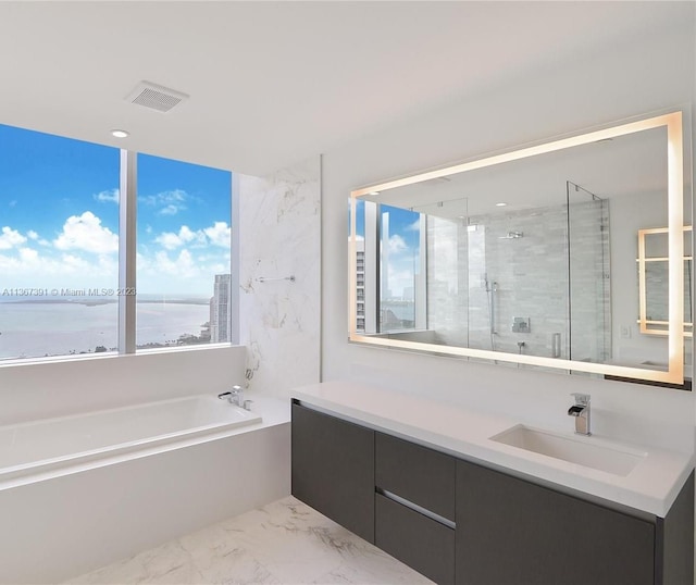 bathroom with vanity, tile flooring, separate shower and tub, and a water view