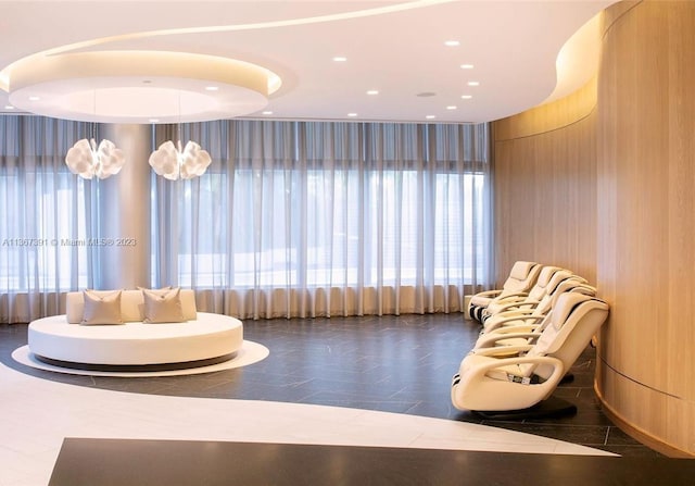 interior space featuring plenty of natural light and dark tile flooring