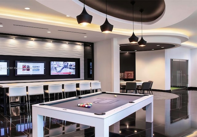 recreation room with dark tile flooring, pool table, and a tray ceiling