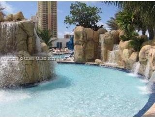 view of swimming pool featuring pool water feature