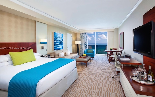 bedroom featuring floor to ceiling windows, a water view, and ornamental molding