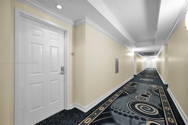 hall with ornamental molding and dark carpet