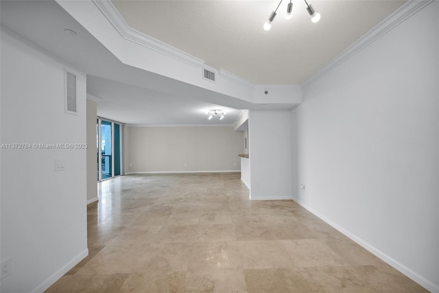 empty room featuring crown molding and light tile flooring