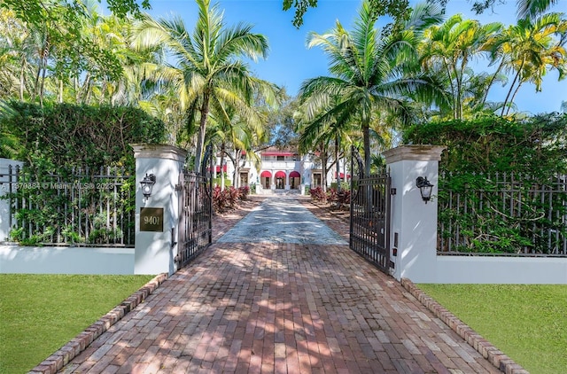 view of gate with a yard