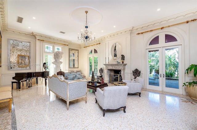 living room with french doors, ornamental molding, and a notable chandelier