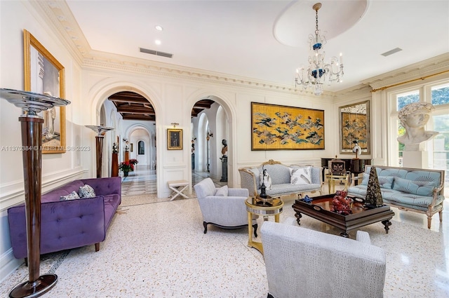 living room featuring crown molding and an inviting chandelier