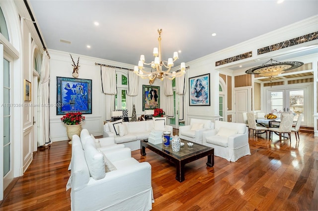 living room featuring a chandelier, dark hardwood / wood-style floors, french doors, and ornamental molding