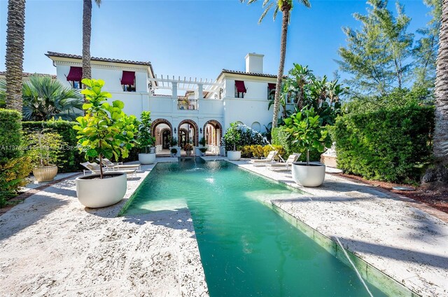 view of swimming pool with a pergola, pool water feature, and a patio