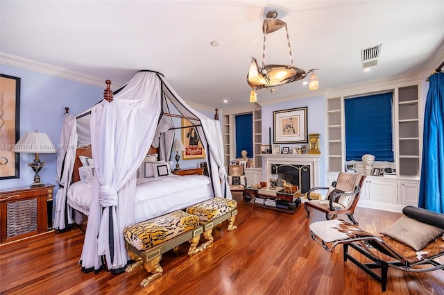 bedroom with dark hardwood / wood-style floors and ornamental molding