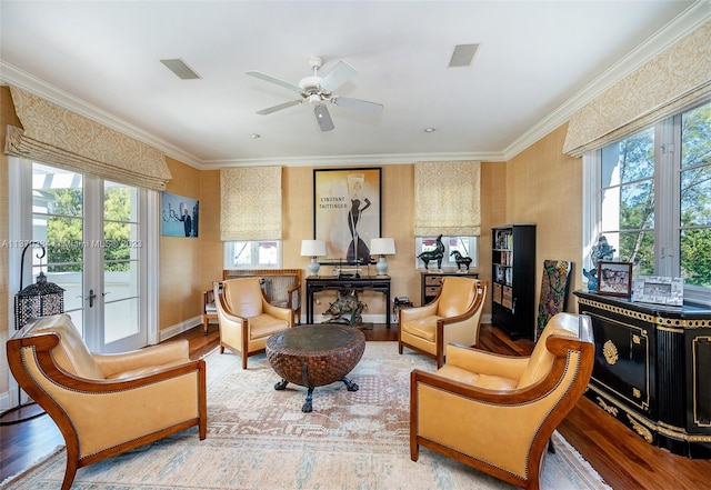 living area with french doors, ornamental molding, ceiling fan, and light hardwood / wood-style flooring