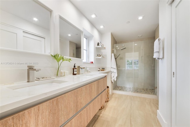 bathroom with walk in shower, tile floors, and double vanity