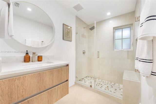 bathroom with vanity, a shower with door, and tile flooring