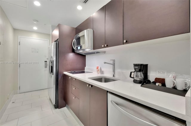 kitchen featuring light tile floors, appliances with stainless steel finishes, and sink