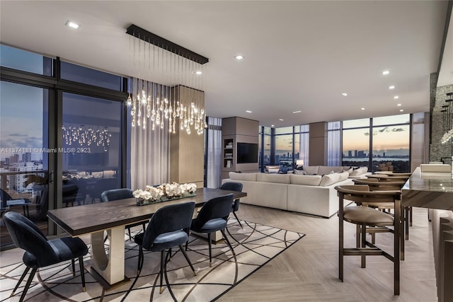 dining area featuring floor to ceiling windows and light parquet flooring