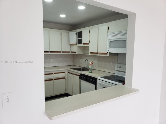 kitchen featuring white appliances, white cabinetry, tasteful backsplash, and sink