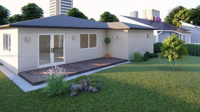 rear view of house with a wooden deck, french doors, and a yard