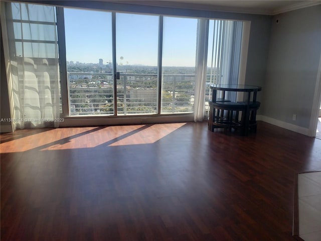 unfurnished living room featuring crown molding and dark hardwood / wood-style floors