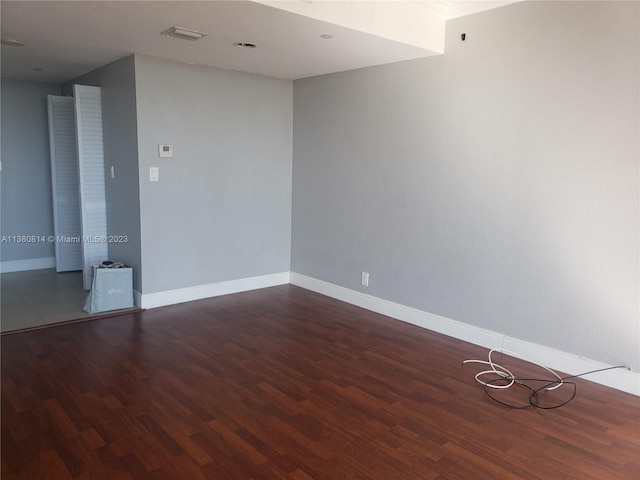 empty room featuring dark hardwood / wood-style flooring