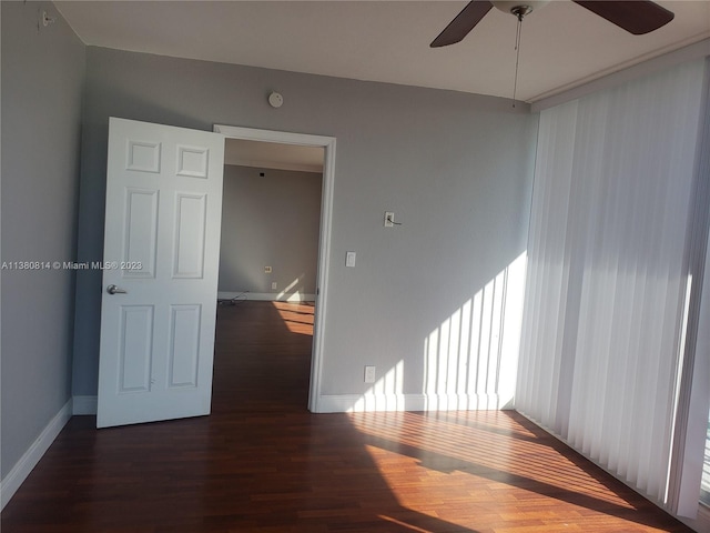 unfurnished room featuring dark hardwood / wood-style floors and ceiling fan