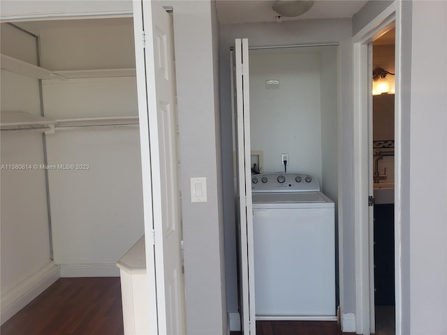 clothes washing area with washer / clothes dryer and dark hardwood / wood-style flooring