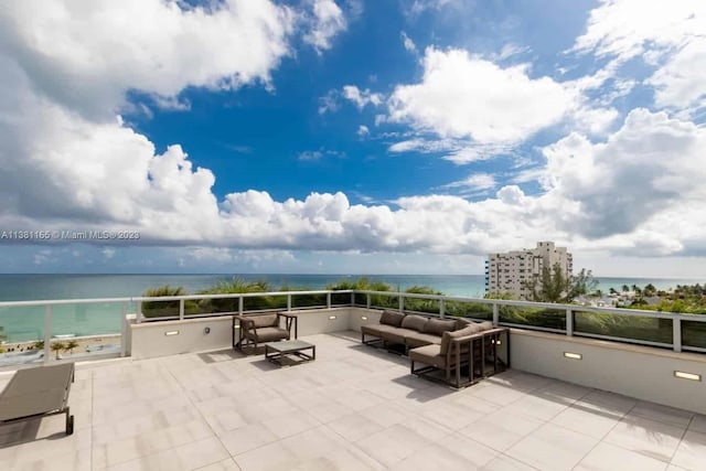 view of patio / terrace with a balcony, outdoor lounge area, and a water view