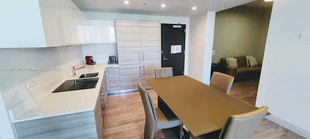 dining area with light hardwood / wood-style floors and sink