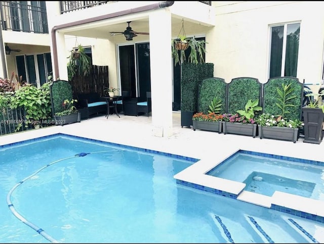 view of swimming pool featuring an in ground hot tub, ceiling fan, and a patio area